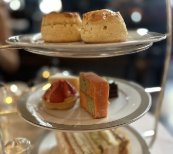 Afternoon tea, o chá da tarde, servido com 2 scones, alguns doces incluindo um Battenberg, e sandíches na base