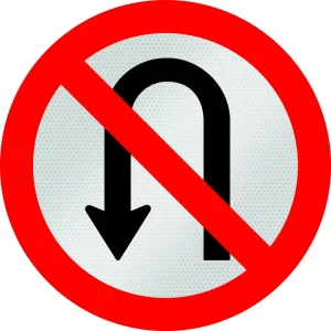 Placa de trânsito circular com borda vermelha, seta preta em formato de U cortada por uma faixa vermelha diagonal, indicando “proibido retornar”.