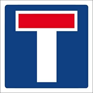Placa de trânsito quadrada azul com símbolo em forma de “T” branco e barra vermelha no topo, indicando “rua sem saída”.